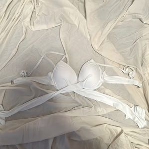 White bathing suit top, the tie crosses in the front than ties around the back.